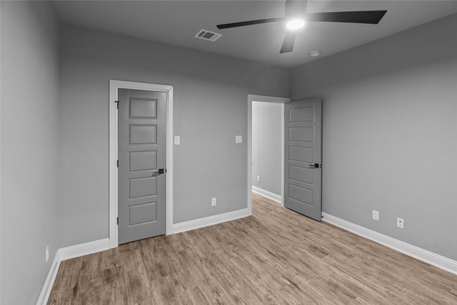 Spare room featuring a ceiling fan, wood finished floors, and a smoke detector | Image 26