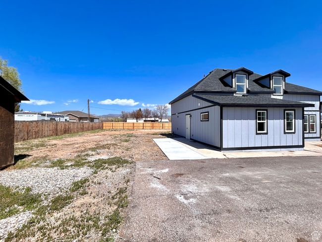 View of side of property with a patio, fence, board and batten siding, and roof with shingles | Image 31