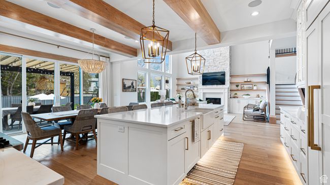 Kitchen with a chandelier, a wealth of natural light, beamed ceiling, and a sink | Image 26