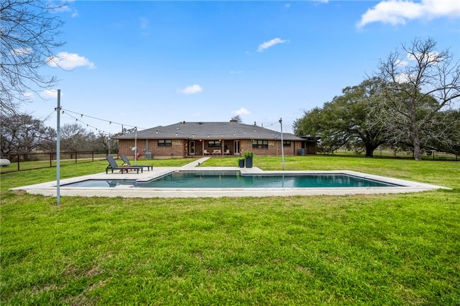 Pool with a yard, a patio area, and fence | Image 46