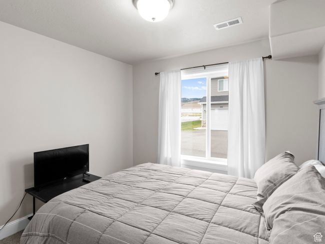 Bedroom with baseboards and visible vents | Image 17