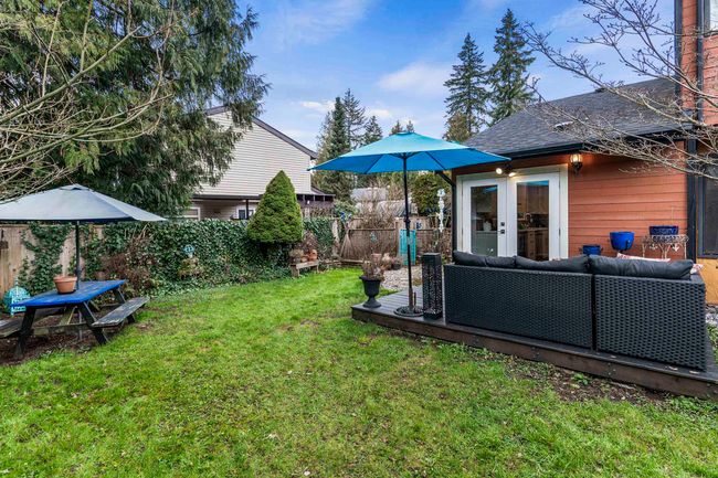 View of yard with fence, french doors, and an outdoor hangout area | Image 36