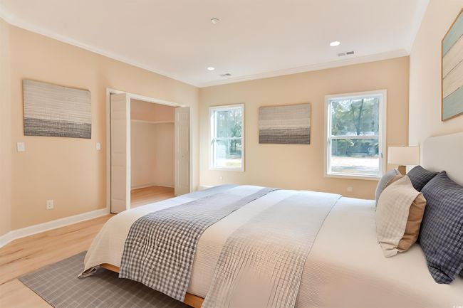 Bedroom featuring wood-type flooring and crown molding | Image 13