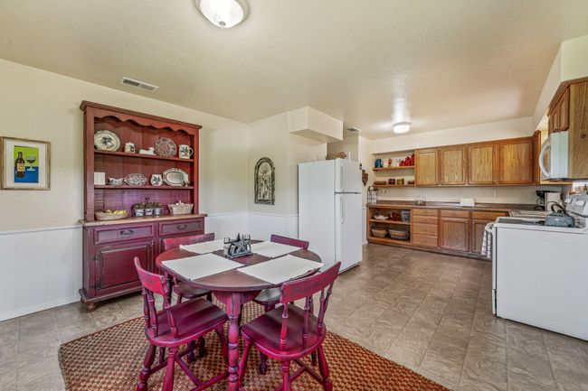 Dining space with wainscoting and visible vents | Image 14