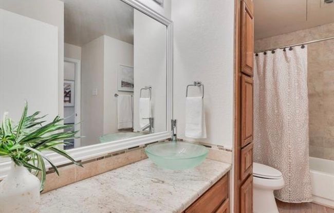 Bathroom featuring vanity and shower / bath combination with curtain | Image 22