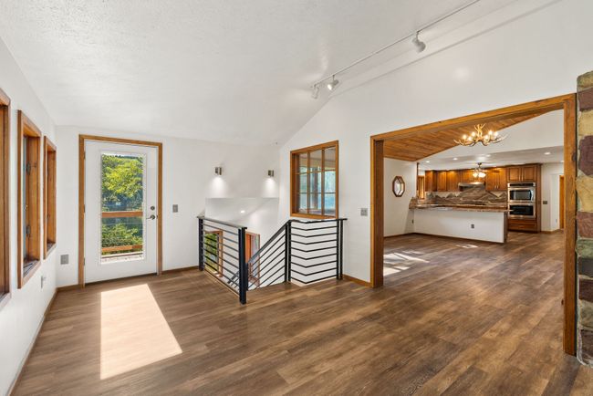 Balcony entrance, stairway & looking towards dining & kitchen | Image 11