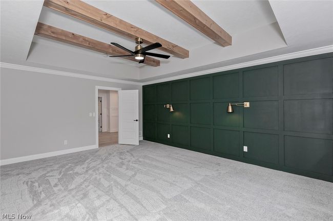 Unfurnished bedroom featuring ceiling fan, ornamental molding, and a tray ceiling | Image 36
