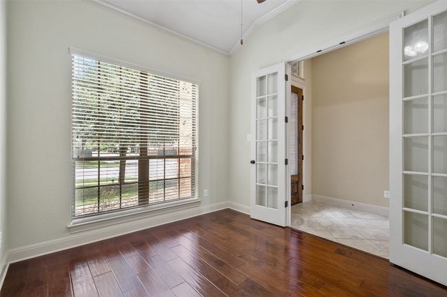 Unfurnished room featuring french doors, crown molding, and wood finished floors | Image 5