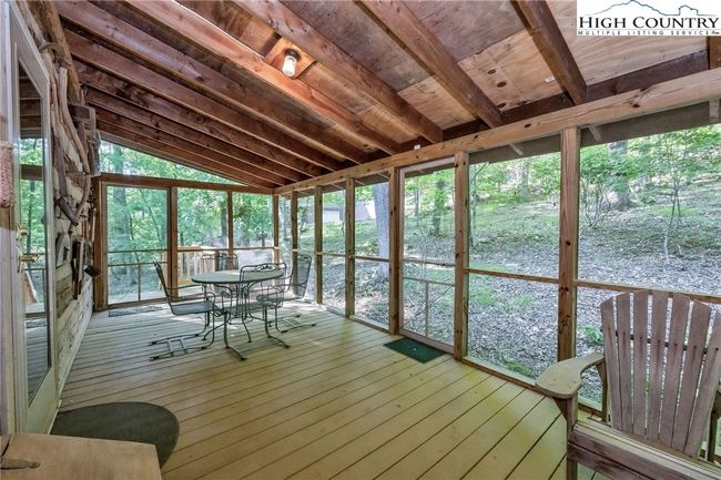 The screened porch lives like an outdoor living room, perfect for morning coffee or sunset cocktails. | Image 27