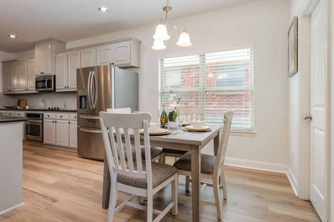 Dining space with a chandelier, light wood-style flooring, and recessed lighting | Image 10