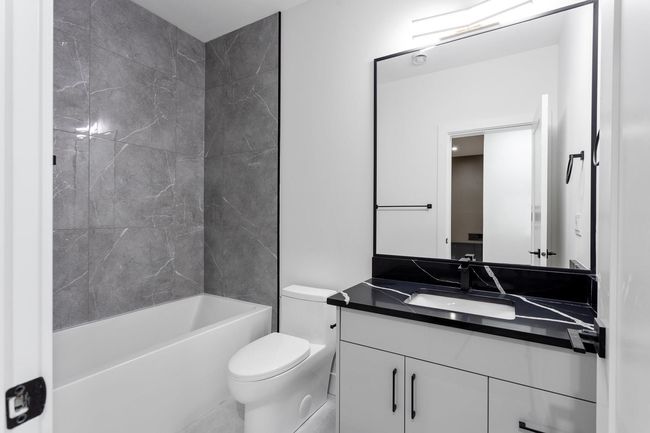 Full bathroom with vanity, bathing tub / shower combination, and toilet | Image 22