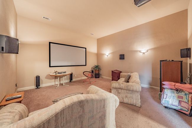Home theater featuring carpet floors and vaulted ceiling | Image 31