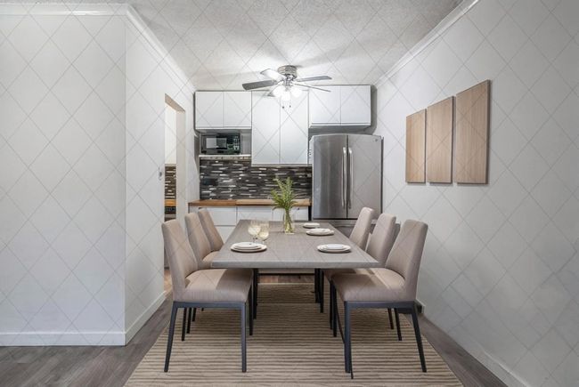 Dining room featuring ceiling fan, wood finished floors, and baseboards | Image 7