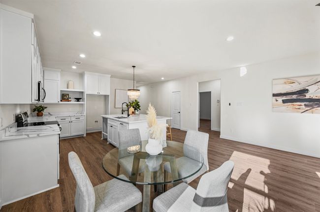 Dining space featuring dark wood-style floors, recessed lighting, visible vents, and baseboards | Image 8