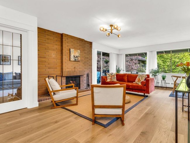 Living area with light wood-type flooring and a fireplace | Image 7