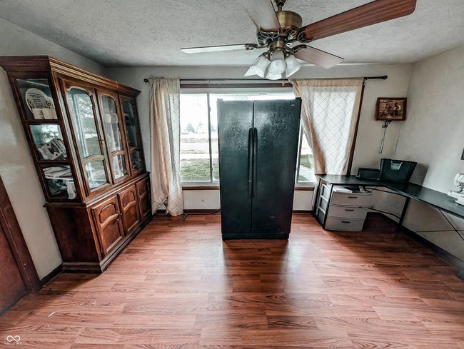 office featuring light wood-style floors, ceiling fan, and a textured ceiling | Image 14