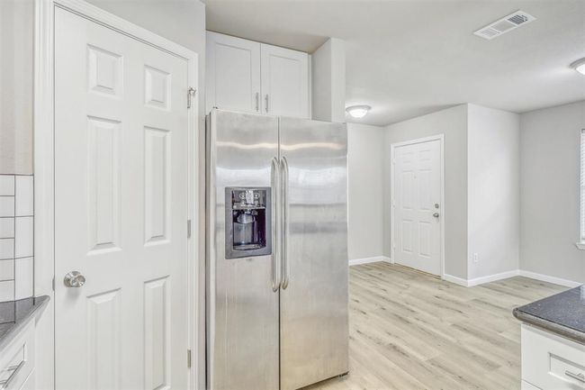 Enjoy easy access to both the fridge space and pantry, making meal prep effortless and efficient in this well-designed kitchen. | Image 14