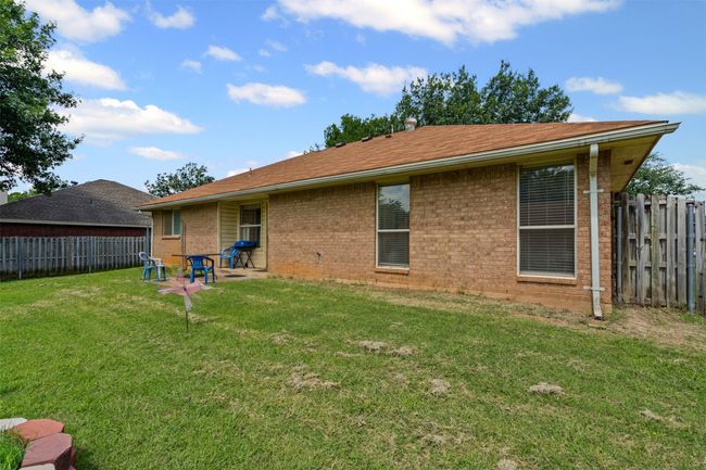 Back of property featuring brick siding and a fenced backyard | Image 21