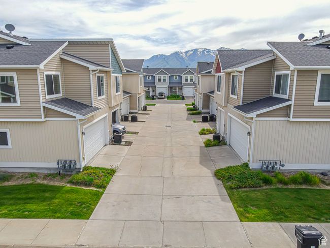 Surrounding community featuring a residential view, an attached garage, a mountain view, and driveway | Image 36