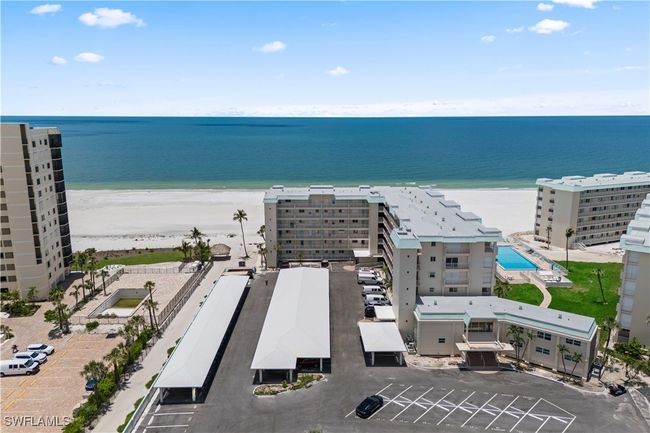 Captured in full, the building is beautifully framed by the endless beach and shimmering ocean, highlighting its prime beachfront location. | Image 26