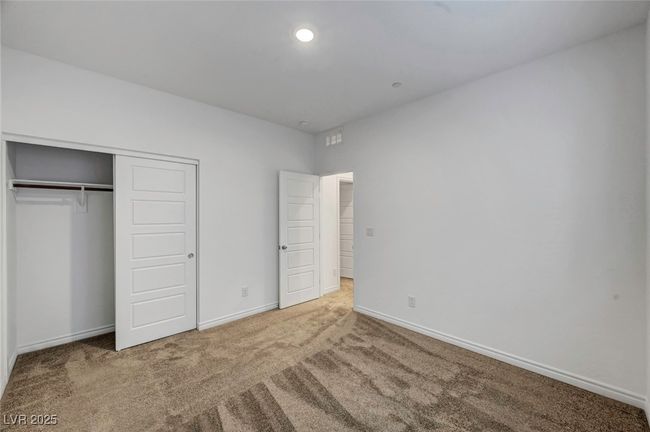 Unfurnished bedroom with a closet, carpet flooring, and baseboards | Image 46