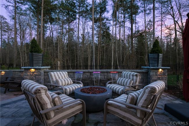 Patio terrace at dusk featuring an outdoor living space with a fire pit | Image 43