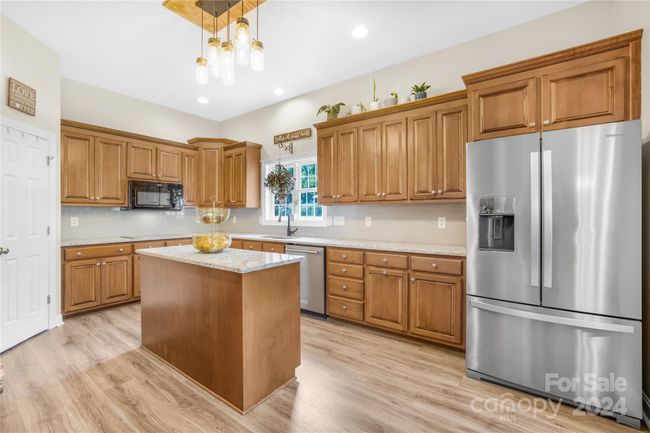 Kitchen features an Island, plenty of cabinet space, double wall over, cooktop and pantry! | Image 8