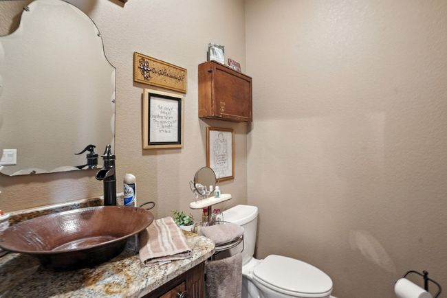 Bathroom with a textured wall and vanity | Image 30