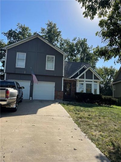 View of front of home with a front lawn and a garage | Image 1