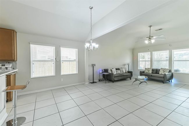 The kitchen opens to the spacious breakfast area and fascinating living room. | Image 11