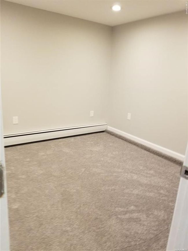 Spare room with a baseboard heating unit, carpet flooring, recessed lighting, and baseboards | Image 10