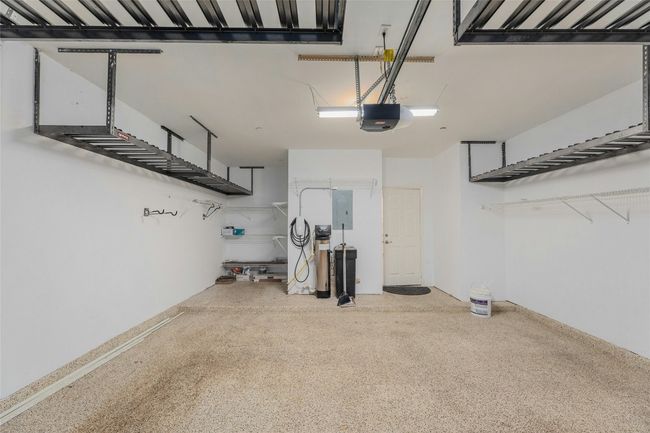 Garage with a garage door opener and electric panel | Image 23