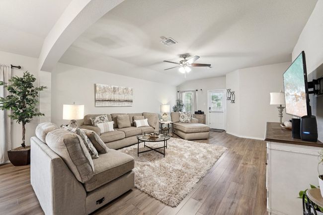 Living room featuring arched walkways, ceiling fan, and wood finished floors | Image 5
