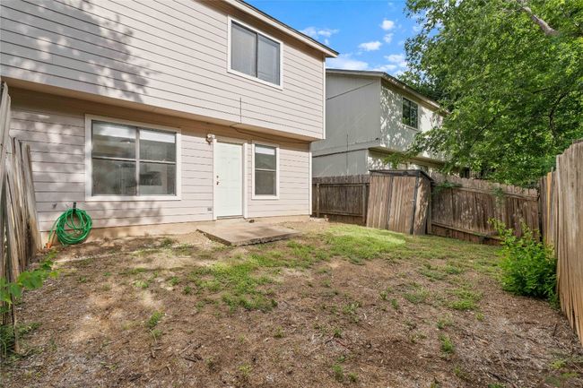 Low-maintenance backyard with concrete patio pad—perfect for outdoor dining or weekend barbecues. Includes storage shed and side access. | Image 15