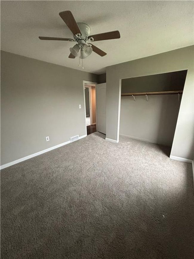 Unfurnished bedroom with a closet, a ceiling fan, visible vents, baseboards, and carpet floors | Image 23