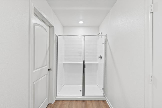 Bathroom with a shower stall and light wood-style floors | Image 8