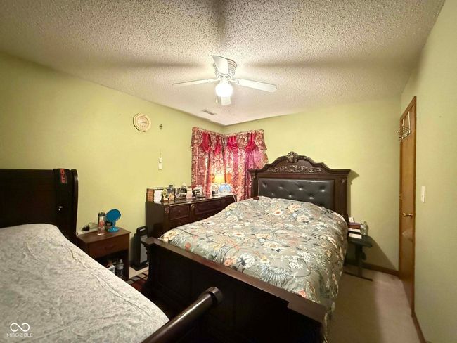 bedroom with ceiling fan and a textured ceiling | Image 17