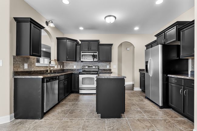 Spacious Kitchen with an Island, Stainless Steel Appliances, Tile Backsplash & Recessed Lighting! | Image 6