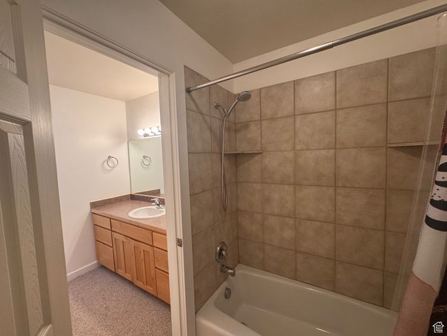 Bathroom with shower / bath combo, vanity, and light colored carpet | Image 9