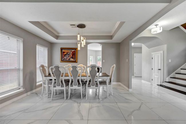 Formal Dining with tray ceilings and crown molding | Image 9