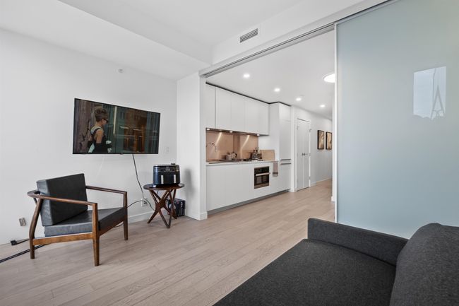 Living area with light wood finished floors and recessed lighting | Image 6