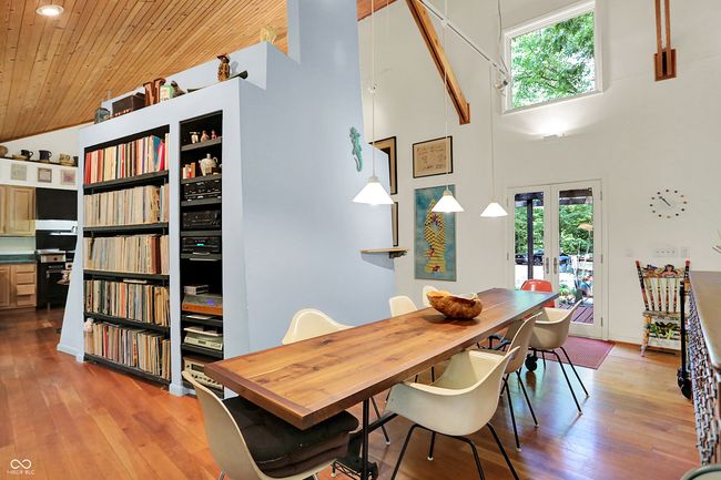 Dining area featuring high vaulted ceiling, plenty of natural light, French doors, wood ceiling, lots of shelving and Cherry hardwood floors | Image 7