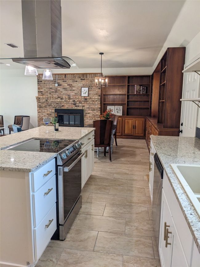 Kitchen featuring stainless steel appliances, open shelves, island range hood, and open floor plan | Image 19