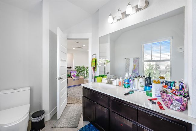 Bathroom with vanity and lofted ceiling | Image 15