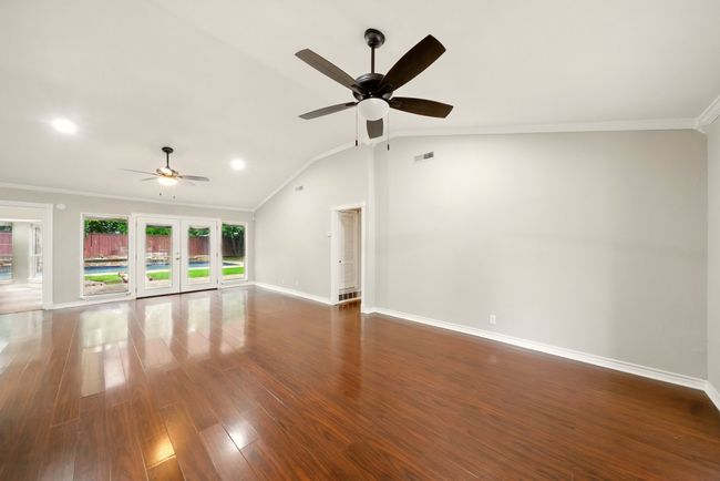 Step inside to a bright, open floor plan where the formal dining room flows seamlessly into the spacious living area—perfect for everyday living and entertaining. | Image 4