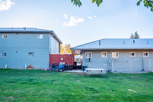 Rear view of property featuring a lawn and a patio area | Image 12