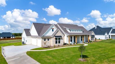 View of front of house featuring cooling unit, a garage, and a front lawn | Image 2