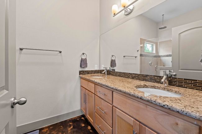 Full bath with a sink, backsplash, a walk in shower, and double vanity | Image 12