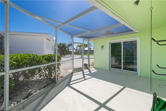 View of sunroom with outdoor shower. | Image 19