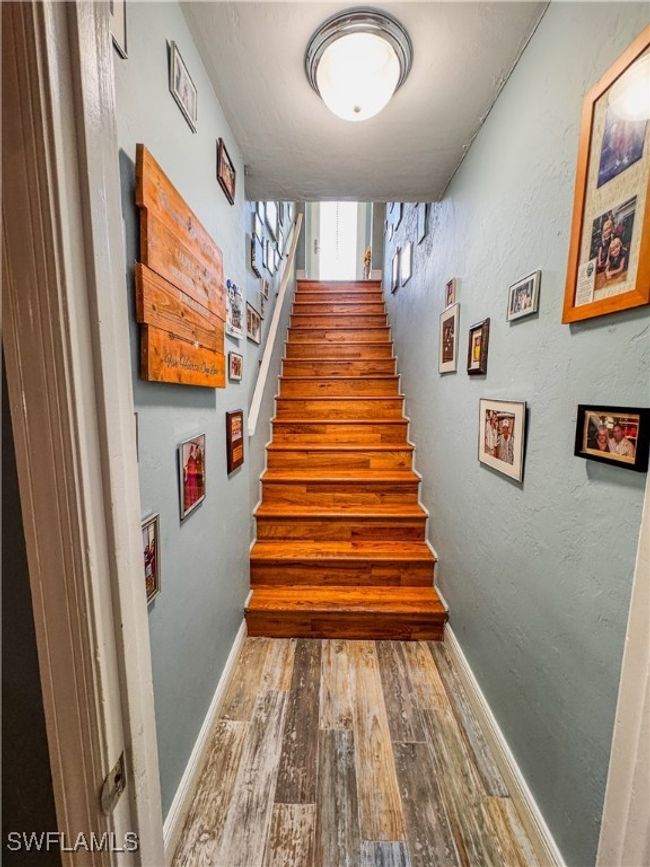 Stairs featuring hardwood / wood-style floors and baseboards | Image 17